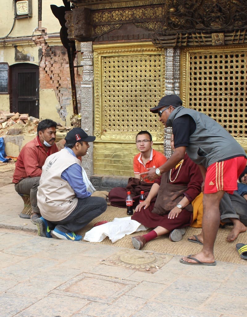 An Islamic Relief aid worker talks to local people about the help they need.